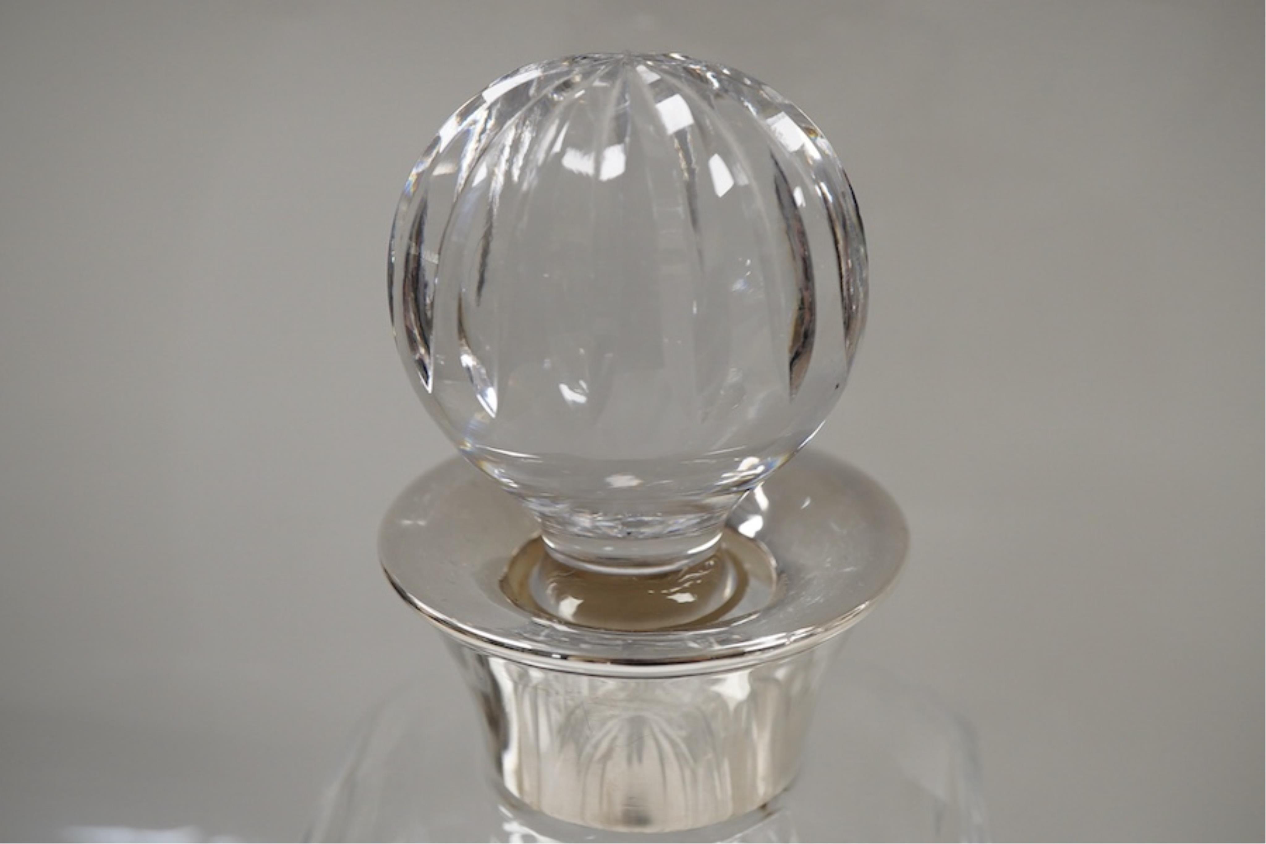 Three assorted silver mounted cut glass decanters, including two modern and one earlier with lock, marks rubbed, no key, the latter 34.1cm.